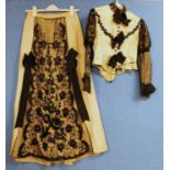 A lady's early 20th Century pale yellow and black jacket and similar skirt, button fronted with