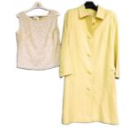 A mid 20th Century yellow coat by Jean Patou, Paris, single breasted with back pleats and button