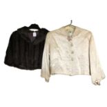 A mid 20th century lady's satin cropped jacket, together with a taupe coloured fur shoulder cape, (