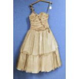 A lady's one shoulder gilt taffeta dress by Frou-Frou, Sandra Ruffell, with two tiered skirt with