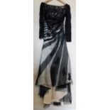 A black and cream gown by Dylan Queen, the cream dress with black net and lace overlay, moulded