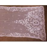A late 19th/early 20th century machine lace shawl, approx. 50 x 246cm long