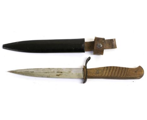 A Second World War German Trench Knife, with 14cm single edge blade double edged at the tip, with blued steel recurving cross