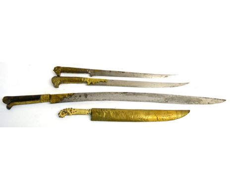 A 19th Century Ottoman Yataghan, the 52cm curved single edge steel blade with punched mark and brass reinforced ricasso, the 