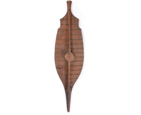 A 19th Century Nias War Shield, Sumatra, of light Sagow wood reinforced with horizontal bands of twisted rattan, with raised 