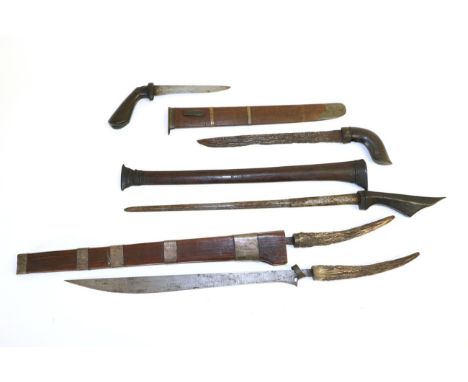 A 19th Century Batak ''Rawit Pengoekir'' (Double Knife), Sumatra, each knife with 35cm straight back steel blade with slightl