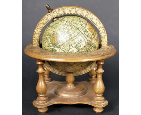 A 20th Century desktop globe having applied terrestrial decorated with signs of the zodiac to the surround supported on four 