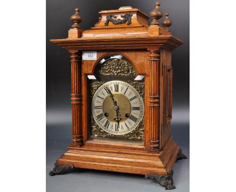 A German walnut-cased bracket clock, (R.M Schneckenburger) having a brass dial with Roman chapter ring framing a matted centr