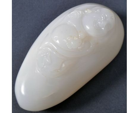 A 19th Century Chinese hand carved white jade panel / toggle. The panel with carved depiction of a Buddha within leaf and hav