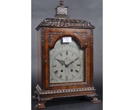 A 19th Century French mahogany pagoda bracket clock having a carved Chinese influence case with carved finial and arched glaz