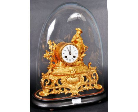 A 19th Century French ormolu mantel clock of decorative form having a white enamel clock face with Roman numeral chapter ring