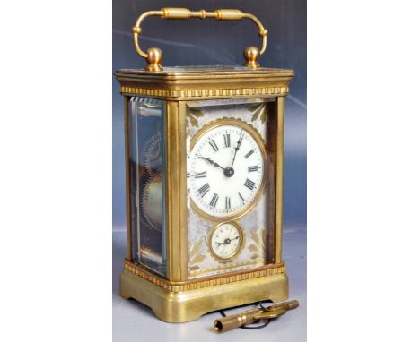 An early 20th Century French quarter repeater carriage clock having a brass case with swing handle atop, ceramic dial with Ro