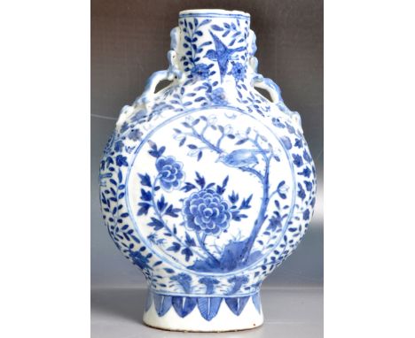 A 19th Century Chinese blue and white porcelain moon flask having hand painted decoration depicting scrolling leaves and bota