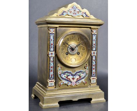 A 19th Century French gilt brass and Champleve enamel table clock / mantel clock. The clock with shaped top section, central 