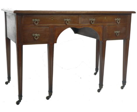 An Edwardian mahogany writing table desk having an inset gilt tooled leather writing sciver with flared table top over a cent