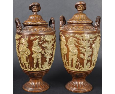 A matching pair of 19th Century Dutch pottery tobacco urns of typical form with each having head finials upon reeded covers f