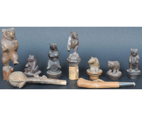 A collection of 19th Century German hand carved Black Forest bear items to include two carved pipes, bottle toppers / topsor 