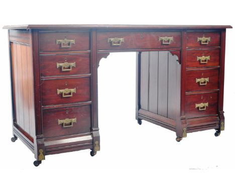 A late 19th Century Victorian Aesthetic movement mahogany twin pedestal writing table desk in the manner of James Shoolbred &