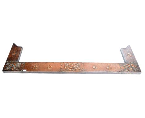 A late 19th Century Victorian Art Nouveau copper fire fender / surround of simple angular flat form having embossed floral de