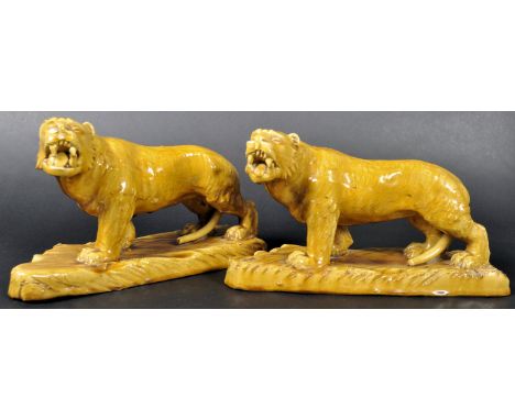 A pair of 19th Century Victorian glazed ceramic tigers with each in a&nbsp;prowling position with mouths open and teeth showi