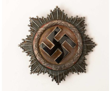A WWII German Cross in silver, with black enamel swastika, silver wreath and some red enamel and sword shaped pin stamped 20.