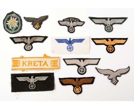 A collection of WWII German cloth insignia, comprising: two German naval breast emblems; two German army breast emblems; two 