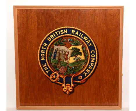 The North British Railway Company door panel with transfer decorated coat of arms on soft wood base, framed, 52 x 52cms.