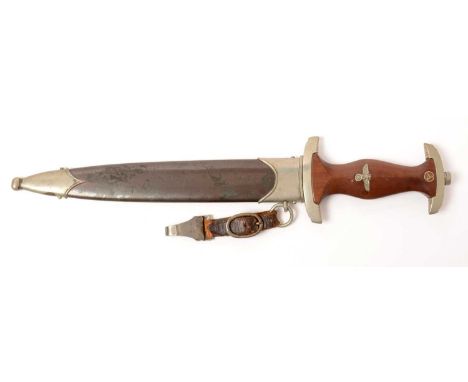 A WWII German S.A dagger and scabbard, the 22.5cms blade marked A. Wreath Solingen, the wooden handle inset with nickel eagle