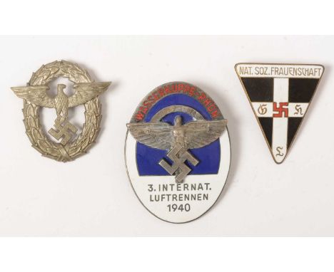 A group of four WWII German badges comprising, A Third International NSFK Rally badge 1940, in blue and white enamels with ne