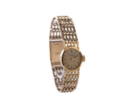LADY'S ROTARY NINE CARAT GOLD MANUAL WIND WRIST WATCH, the champagne dial with applied baton hour markers, 13mm case, on a ni
