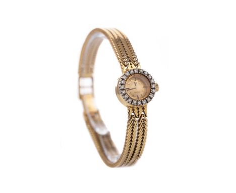 LADY'S OMEGA EIGHTEEN CARAT GOLD AND DIAMOND MANUAL WIND WRIST WATCH,the round champagne dial with applied baton hour markers
