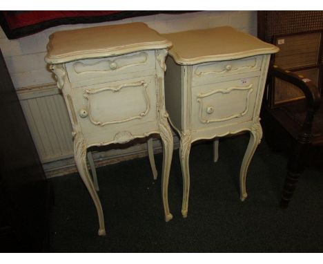 A matched duo of French style bedside cabinets painted in shabby-chic cream, each with single drawer over cupboard and standi