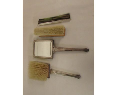 A 1960's silver backed dressing table set comprising hand mirror, two brushes and comb, engine turned in squared-off design, 