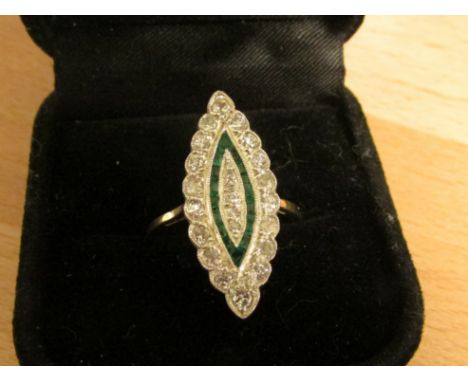 Diamond and emerald ring in a marquise setting (25mm x 10mm), perimeter of eighteen diamonds (estimated at 0.03 carat each), 