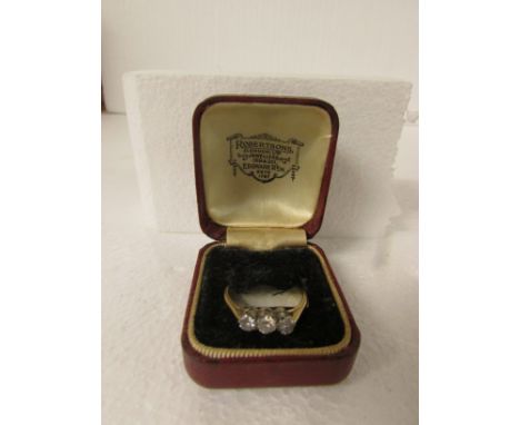 Three stone diamond engagement ring on 18ct gold shank with platinum setting, largest stone estimated at 0.2 carats