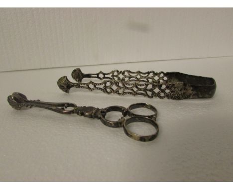White metal scissor sugar nips, scroll and loop handles, scallop grasps, engraved M*K at the hinge, indistinct stamped marks,