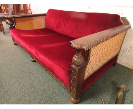 Three seater cane-end Bergere low backed sofa upholstered in goose feather and horse hair in claret red velvet, the frame in 