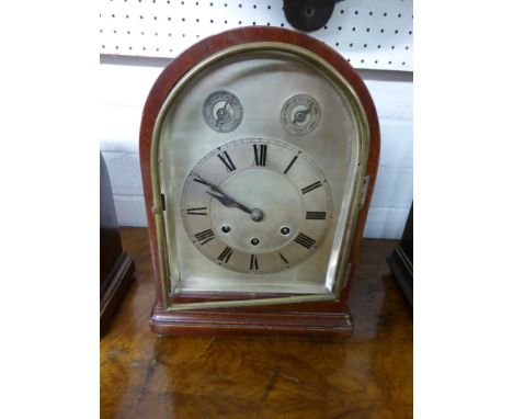 An Edwardian mahogany dome shaped striking mantle clock with subsidiary slow /. fast and silent / chime dials. The Roman nume