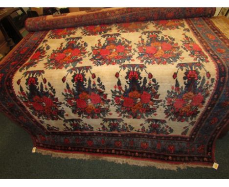 Persian carpet on white ground patterned with vases of flowers, blue and red margins (154cm x 208cm)