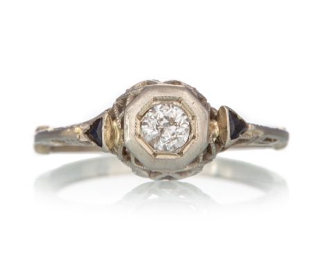 the illusion set diamond of approximately 0.15 carats, flanked by small sapphires, marked 14K, size K 1/2 2g   