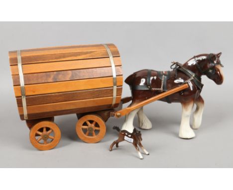 A ceramic figure of a shire horse with gypsy caravan along with a Beswick chestnut foal.