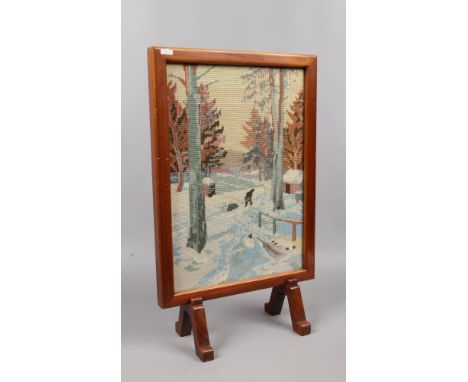A hardwood woolwork fire screen, woodland snow scene.