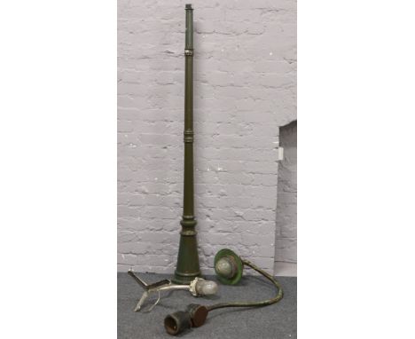 A vintage cast iron street light, along with a steel corner light and a modern garden light column base.