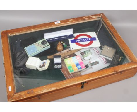 A bijouterie case containing mixed collectables include costume jewellery, enamel private sign and advertising coat hanger et