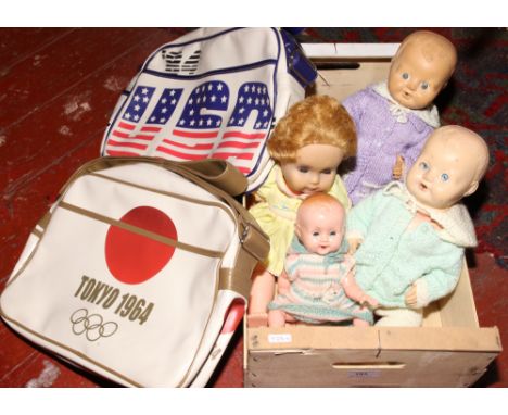 Two vintage sport satchels, along with four dolls formed as babies.