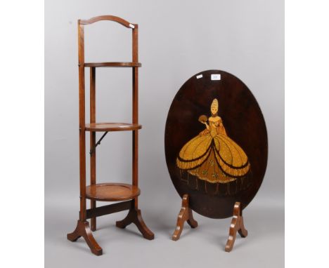 A carved oak three tier folding cake stand along with a decorative fire screen.