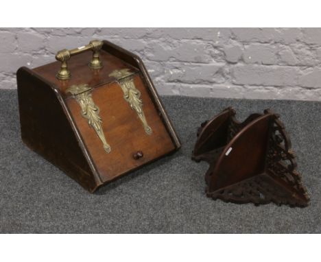 An early 20th century mahogany coal scuttle with brass mounts, along with a two tier corner shelf with fretwork decoration.