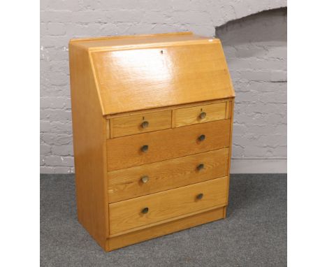 A light oak bureau with fitted interior.