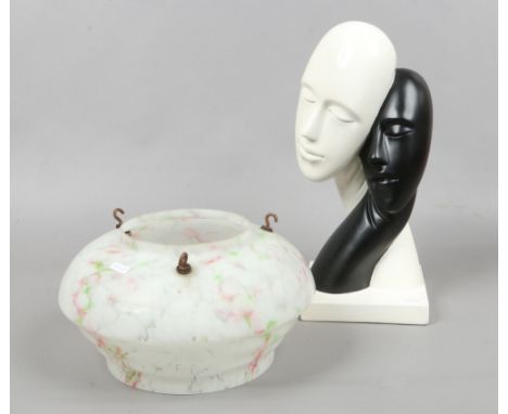 An ebony and ivory coloured composite bust depicting two lovers, along with an Art Deco light shade.