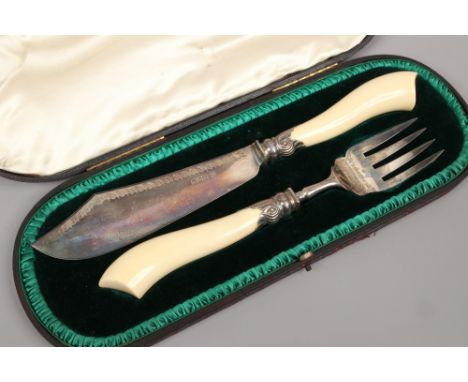 An Edwardian cased silver carving set with ivory handles, assayed London 1904 by R. H. Halford &amp; Sons Ltd.